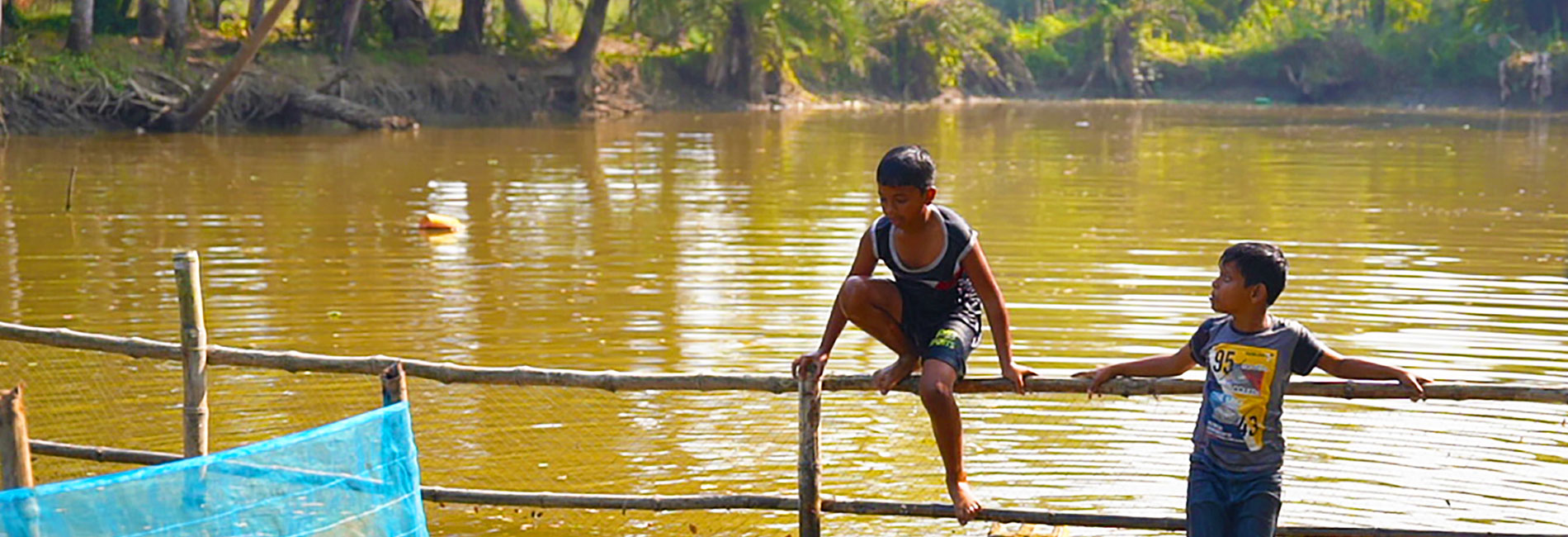 Two boys standing in the river