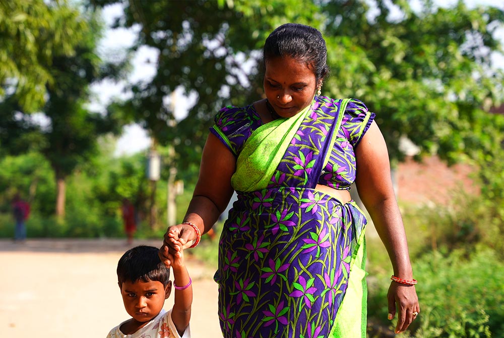 Sravanthi holding her son's hand