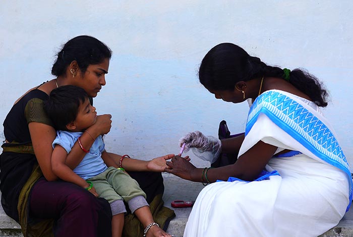 ASHA helping a woman and child