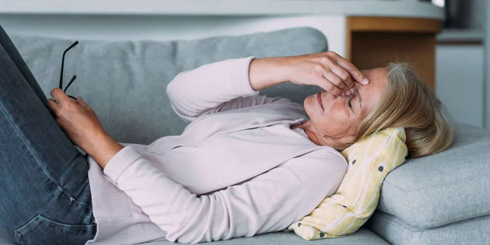 Woman lying down with a headache