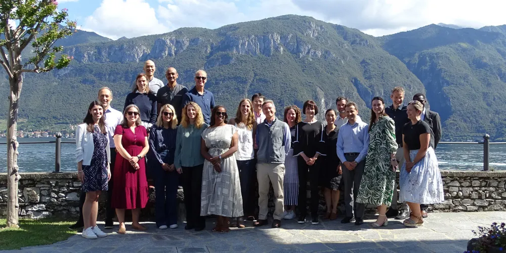 Group of people standing infront of a lake
