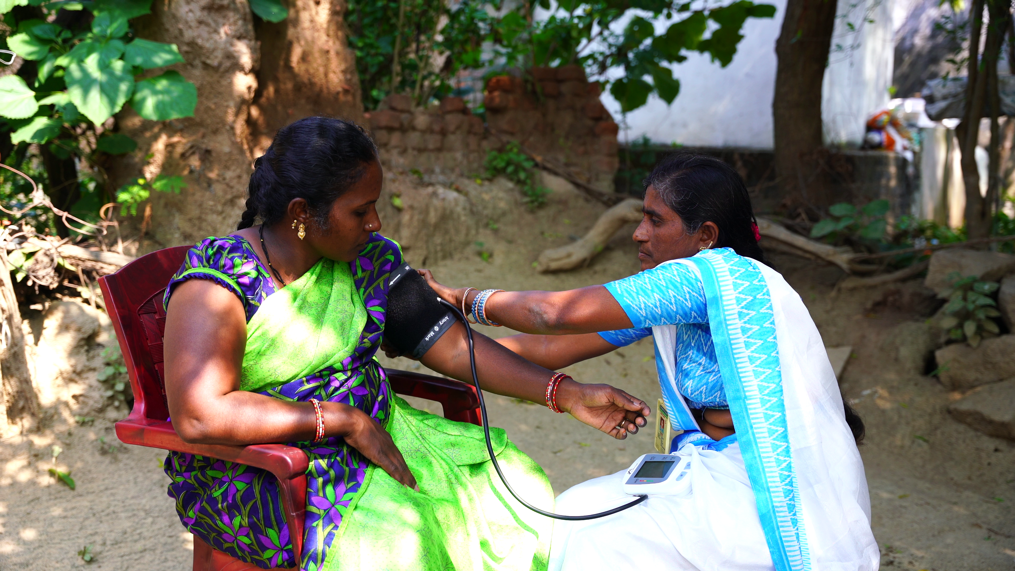 Svranthi having her blood pressure checked by the ASHA, which will then be logged into the SMARThealth app
